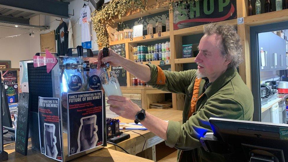 Greg Pilley pulling a pint behind the bar at Stroud Brewery