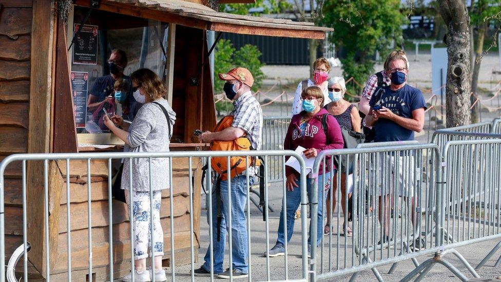 Park visitors are seen wearing protective face masks at the entrance of Pairi Daiza wildlife park