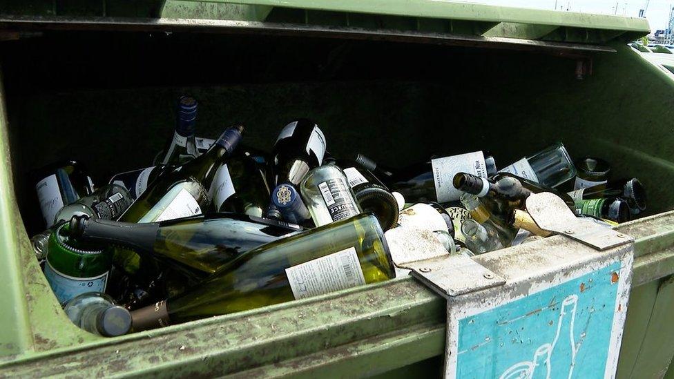 Glass bottles in a glass recycling bin at Salerie Corner, Guernsey