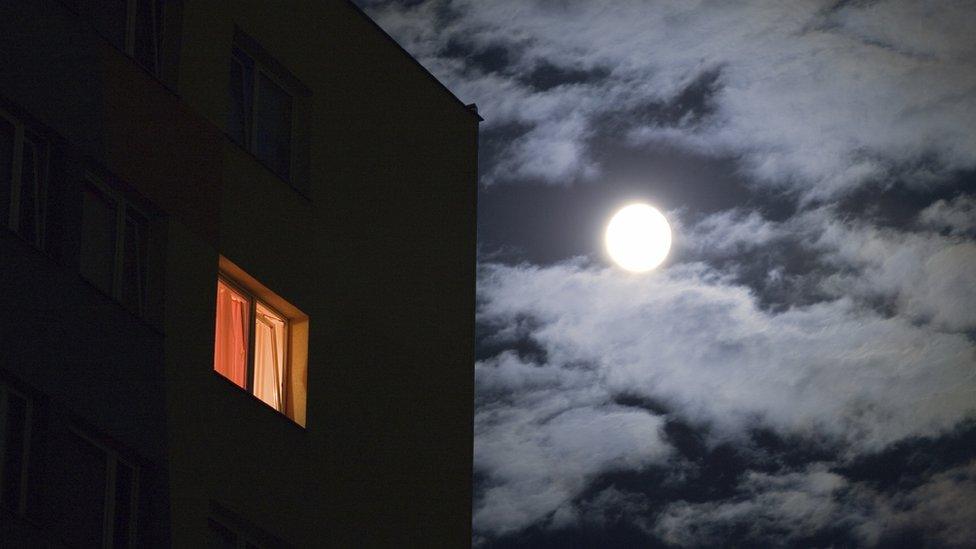 House in dark with bedroom light on