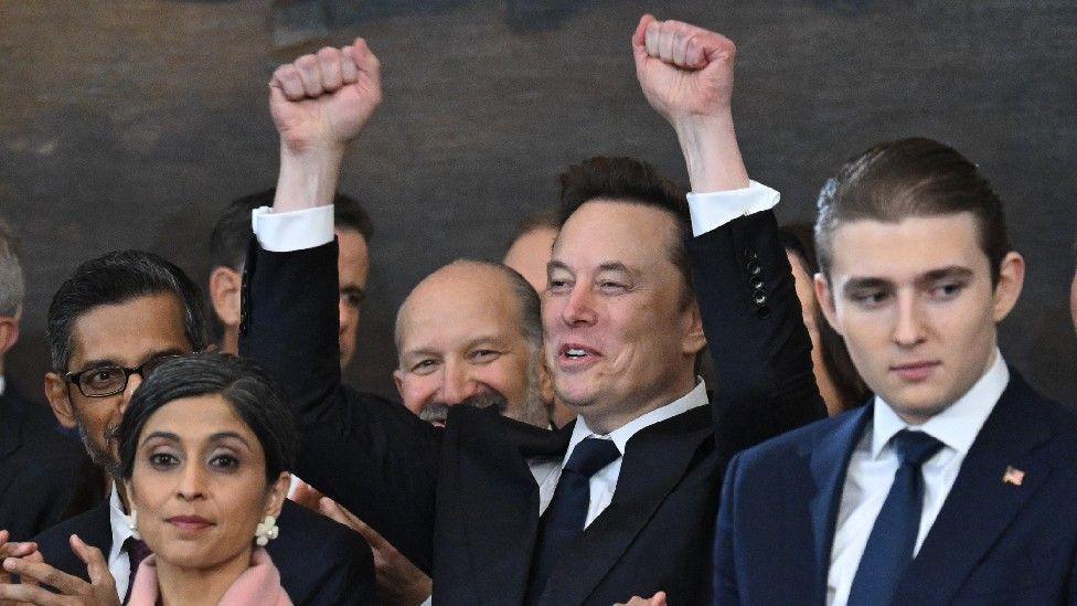 Elon Musk holds his fists in the air during the inauguration of Donald Trump