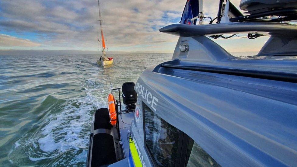 The police boat tows the yacht