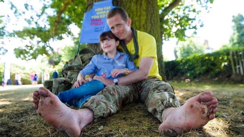 Hasti pictured with her dad - injuries to his feet visible