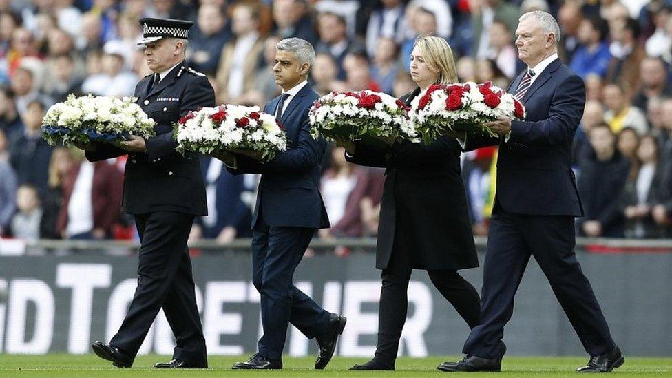 Sadiq Khan carrying wreath at England v Lithuania football match