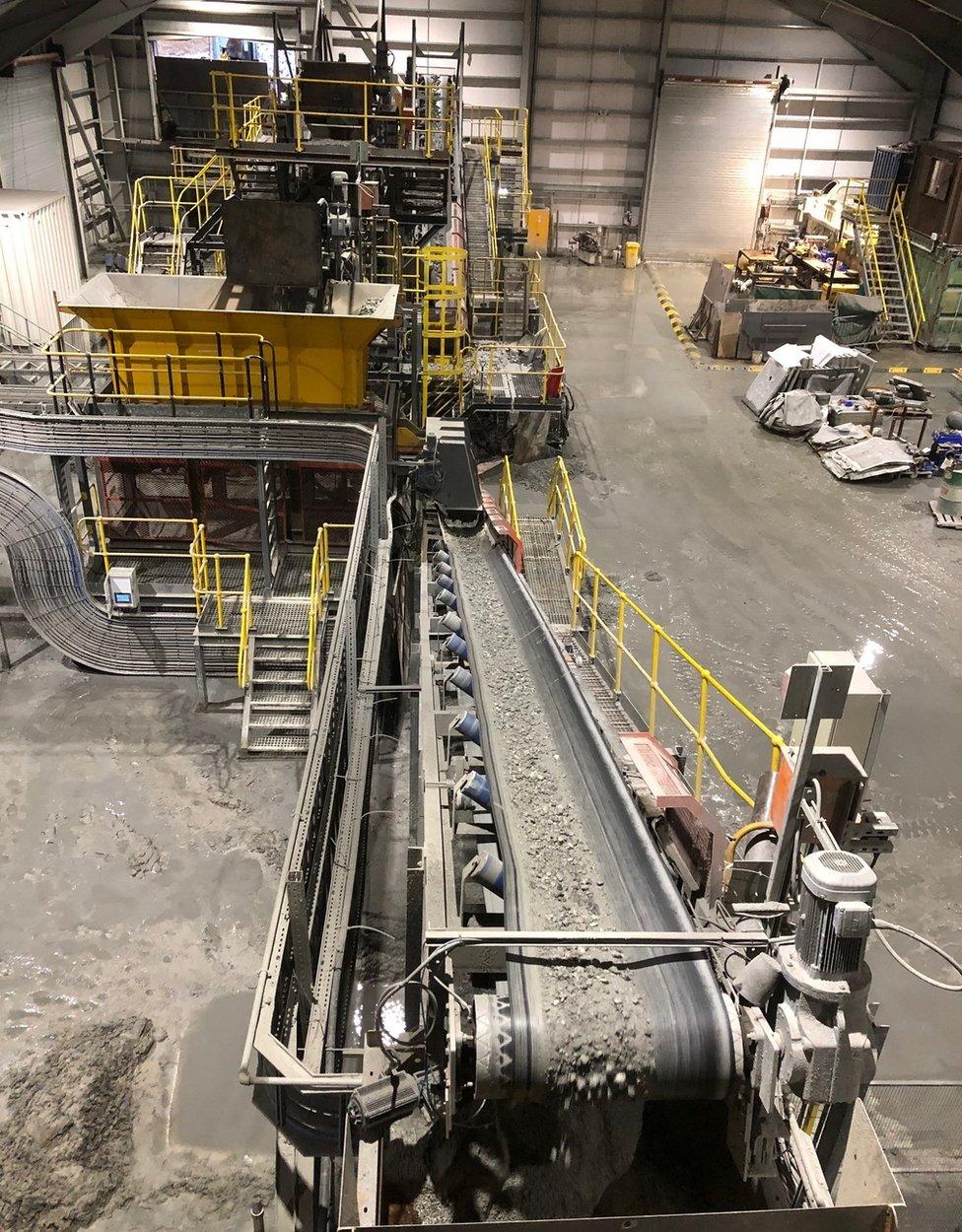 Rocks on conveyor belt in processing plant at Cononish mine