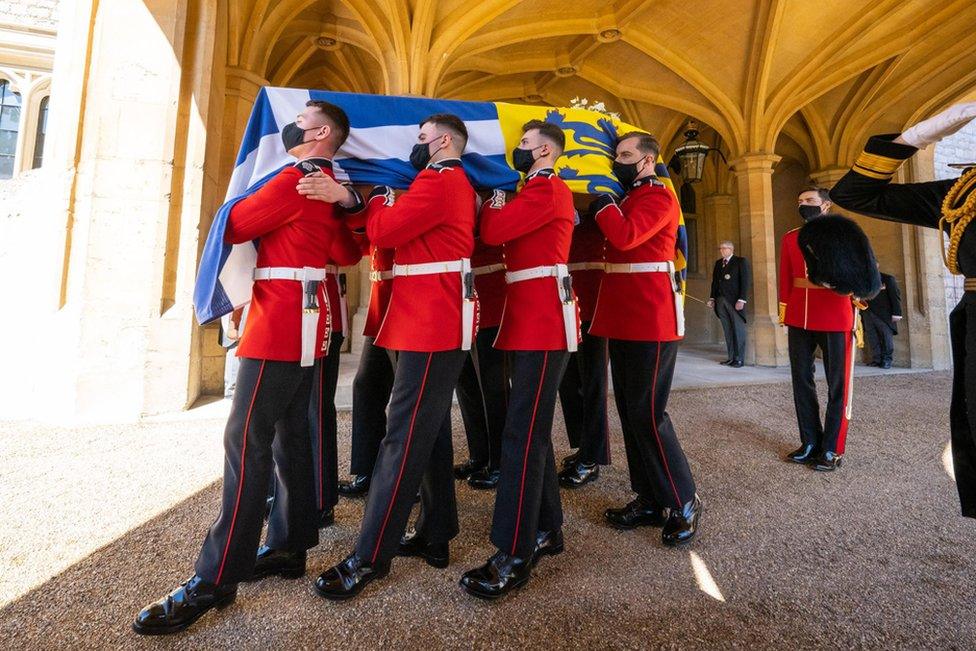 The Duke of Edinburgh's coffin, covered with his Personal Standard, is carried to the purpose built Land Rover Defender ahead of the funeral of the Duke of Edinburgh in Windsor Castle, Berkshire. Picture date: Saturday April 17, 2021