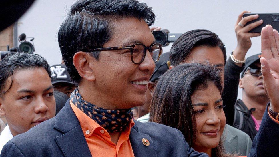 Madagascar's President and a presidential candidate Andry Rajoelina flanked by his wife Mialy Rajoelina as he arrives to cast his ballot at a polling station, during the presidential election in Ambatobe, Antananarivo, Madagascar November 16, 2023.