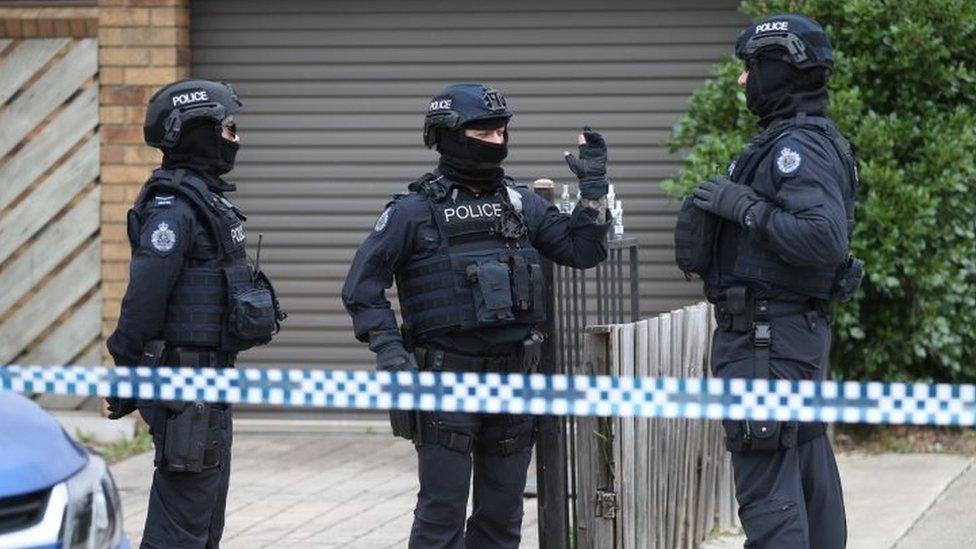 Heavily armed police officers involved in raids in Melbourne on Tuesday