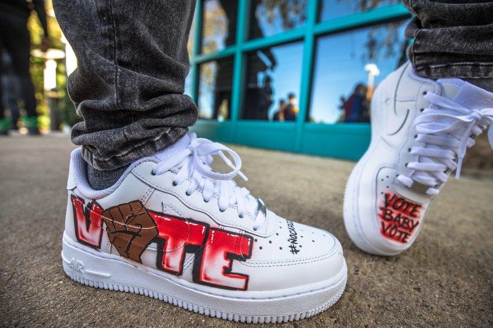 A pair of shoes with voting messages drawn on