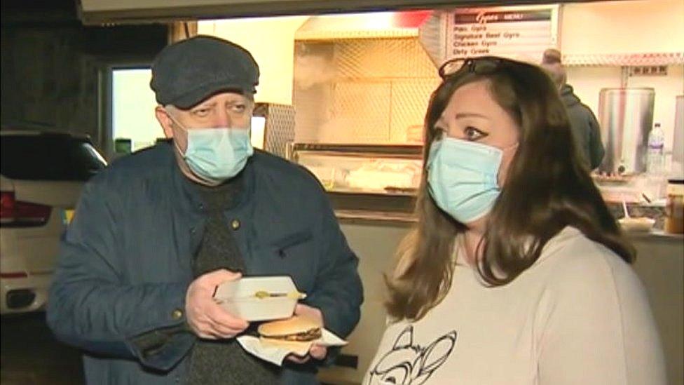 Gordon and Dawn Clarke collecting hot food from a takeaway van