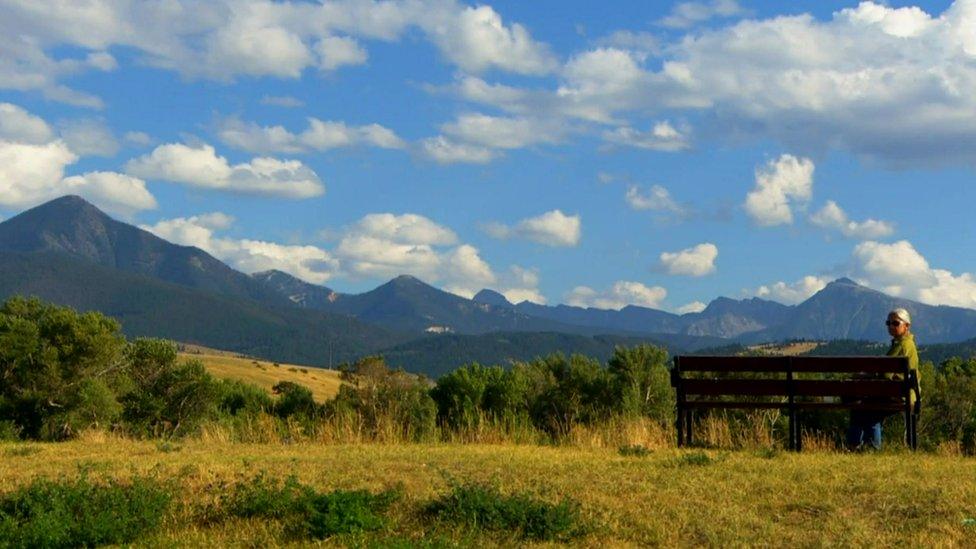 Scenic mountainous Montana view with one person sitting in shot