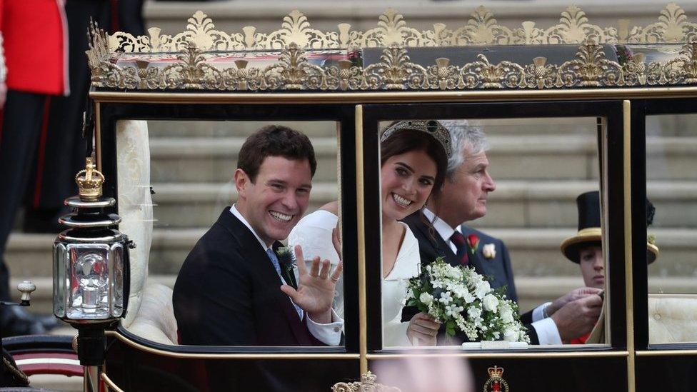 Princess Eugenie of York and her husband Jack Brooksbank walk down the West Steps of St Georg's Chapel