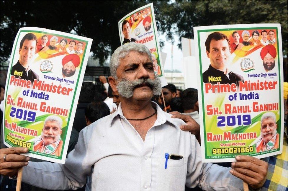 A Congress party supporter holds placards in support of Rahul Gandhi for the country"s next prime minister outside the party headquarters in New Delhi on December 11, 2018, as