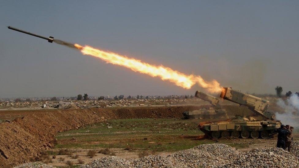 Iraqi security forces launch a rocket against Islamic State militants positions during clashes in the western side of Mosul, Iraq, Sunday, March 5, 2017