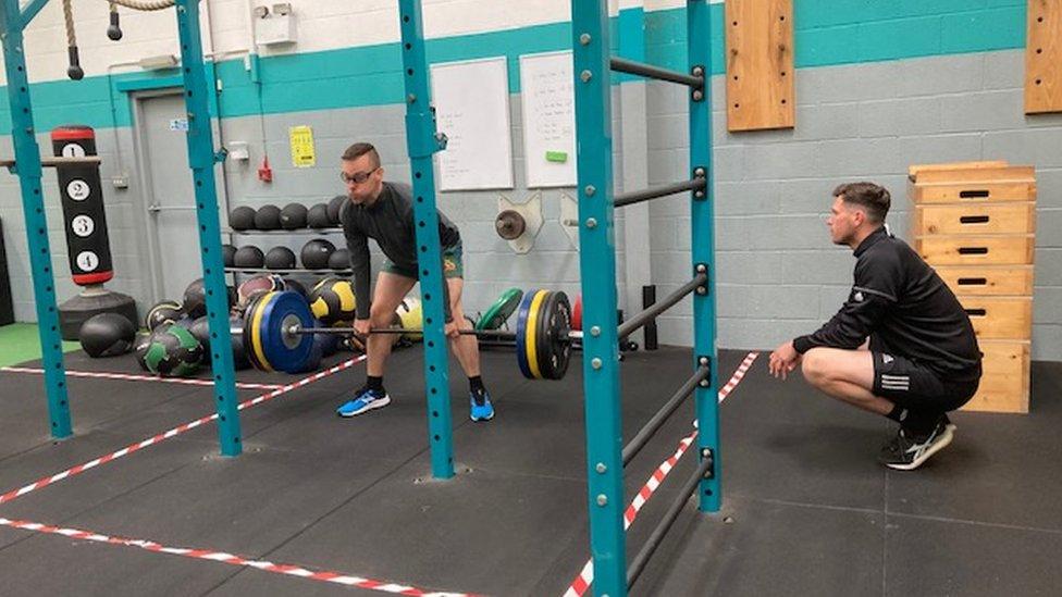 Andrew in weights' rack with personal trainer Chris Hibbert