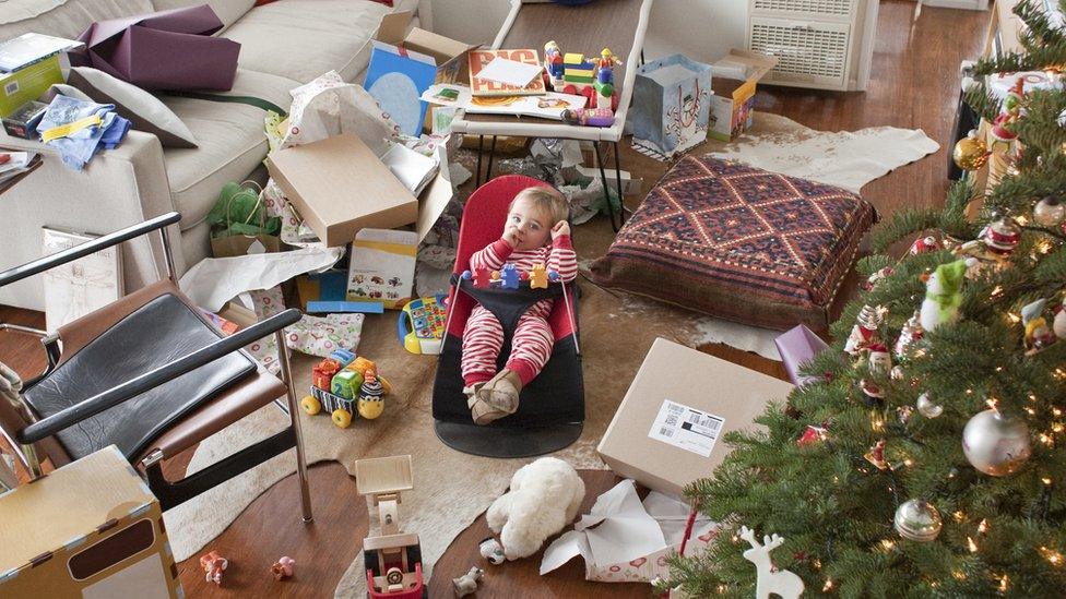 Baby surrounded by recycling