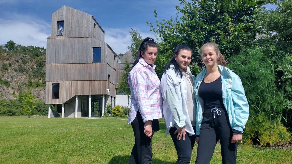 Three women outside a food factory