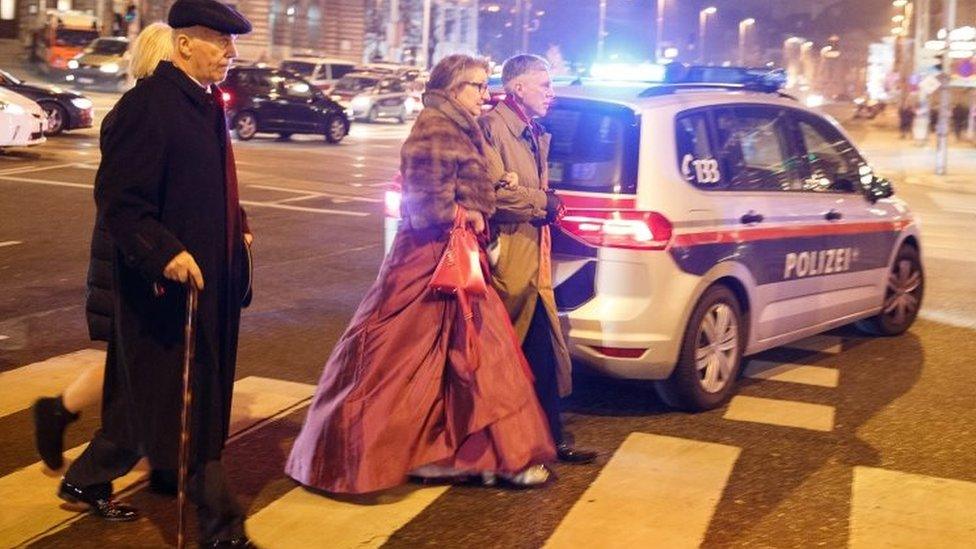 Ball guests walk past a police car. Photo: 26 January 2018