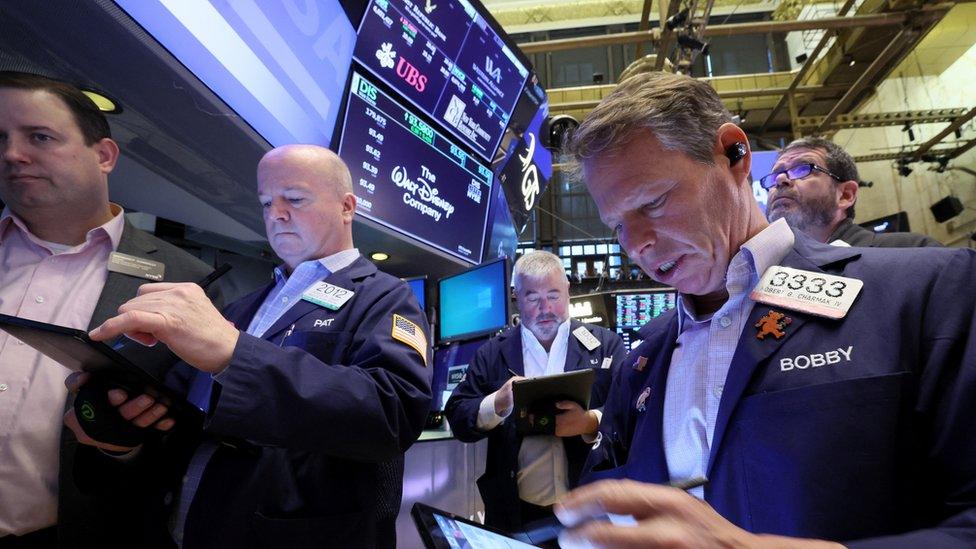 Traders work on the floor of the New York Stock Exchange (NYSE) in New York City, U.S., March 20, 2023. REUTERS/Brendan McDermid