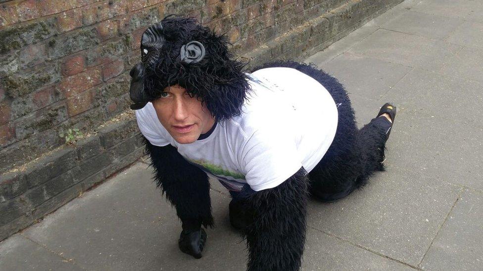 Gorilla man crawling on pavement