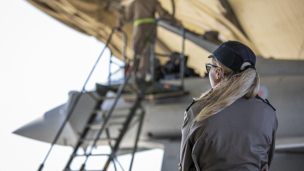 Female Royal Air Force Weapons Technician and Aircraft Technician working on an RAF Typhoon