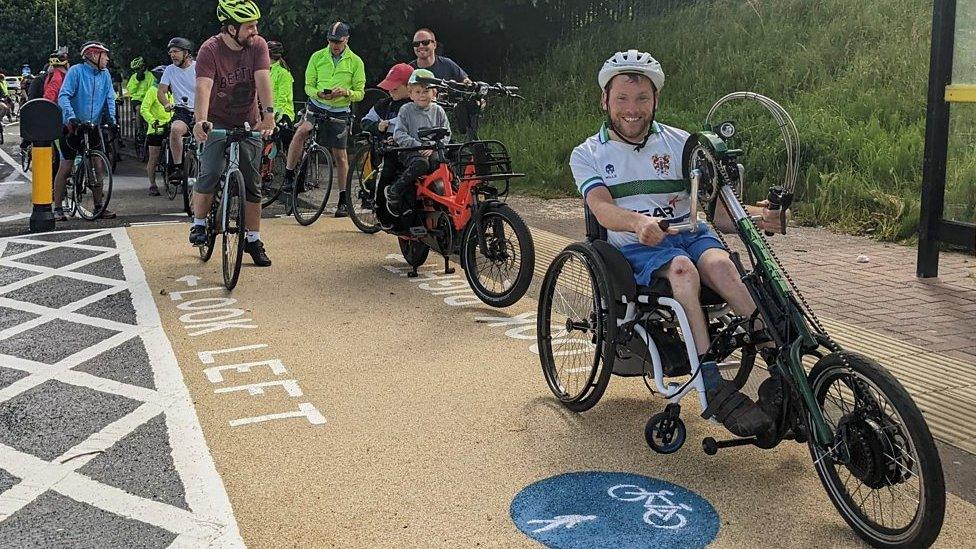 BBC Radio Merseyside's Ellis Palmer and his handcycle at the Fender Lane cycle path