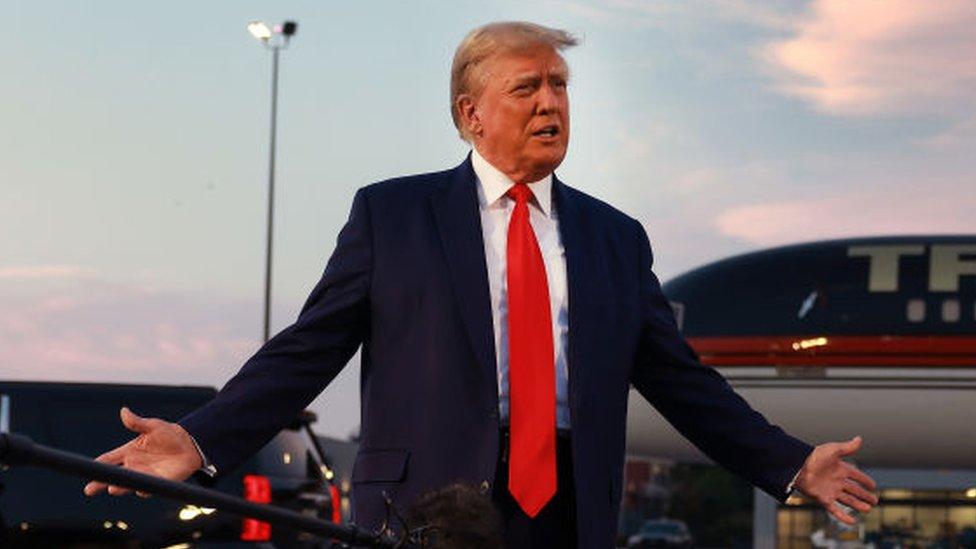 Former US President Donald Trump speaks to the media at Atlanta Hartsfield-Jackson International Airport after surrendering at the Fulton County jail on 24 August 2023 in Atlanta, Georgia.