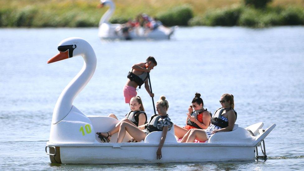 Women on a pedalo in Nene Park, Peterborough enjoy warm weather in August