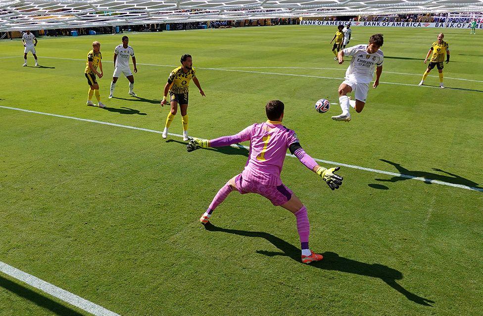 Gonzalo Garcia of Real Madrid scores his team's first goal past Gregor Kobel of Borussia Dortmund during the FIFA Club World Cup 2025 quarter-final in New Jersey.