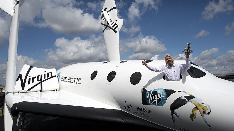 British billionaire Richard Branson in the window of a replica of Virgin Galactic, the world’s first commercial space liner, Farnborough 2012