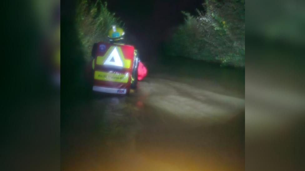 High flood water with worker battling through the water