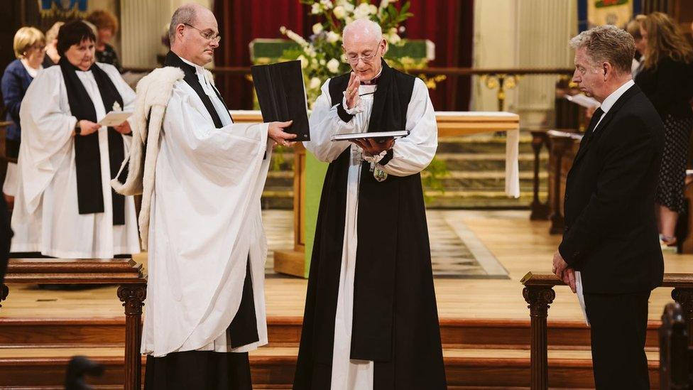 The Bishop with the book of commemoration