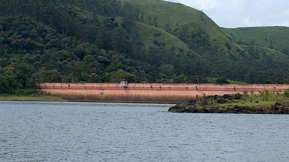 File photo showing Mullaiperiyar Dam stretching from the lake to a luscious hillside with trees