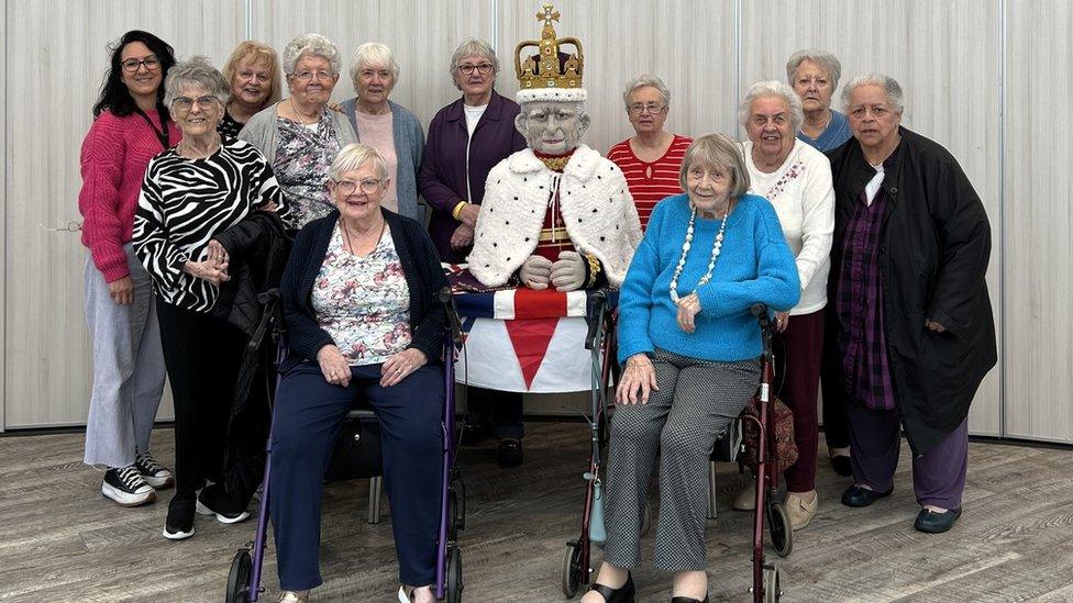 The Knit and Natter group with the model of King Charles