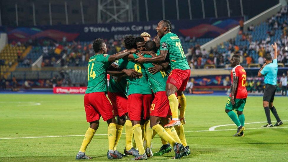 Cameroon players celebrate a goal