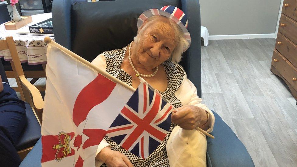 Elizabeth Neville holding Union and Ulster flags