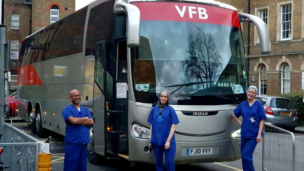 NHS staff outside one oft he buses