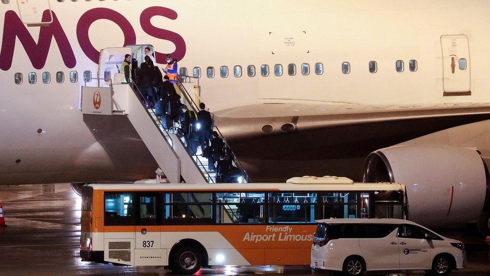 People boarding evacuation flight at Haneda Airport