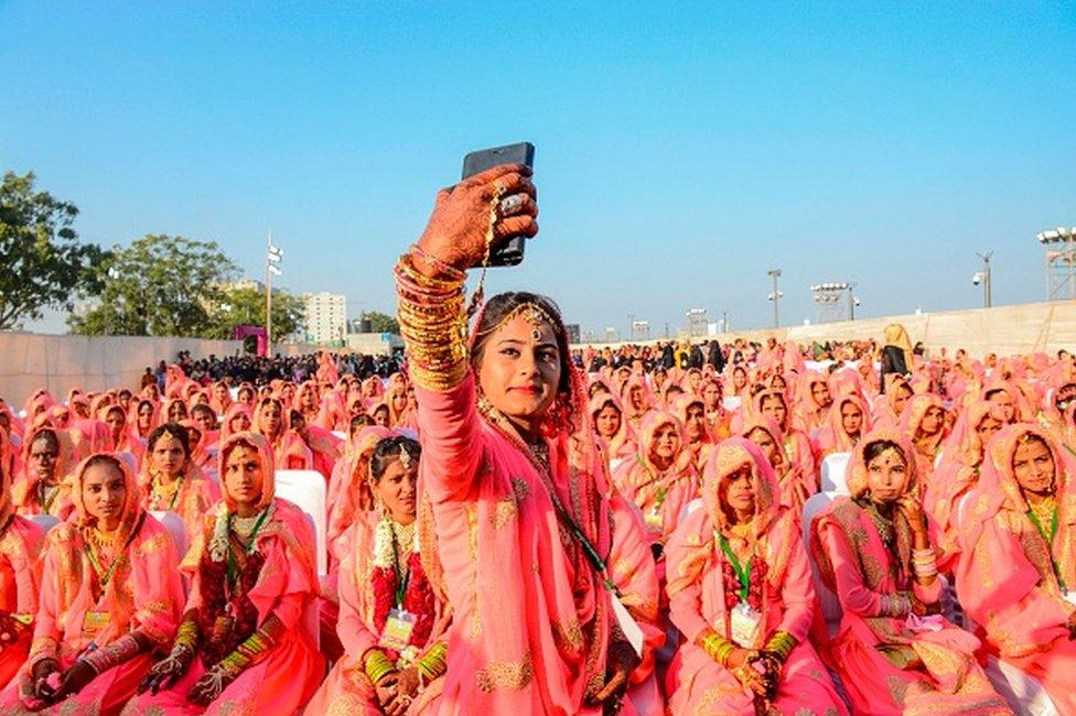 A Muslim bride takes a selfie with her mobile phone as she participates in an 'All Religion Mass Wedding' ceremony at Sabarmati Riverfront in Ahmedabad on February 8, 2020. (Photo by SAM PANTHAKY / AFP) (Photo by SAM PANTHAKY/AFP via Getty Images)