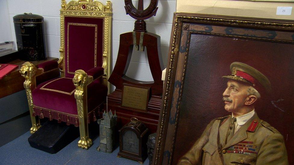 A throne chair, an ornamental bell stand and a portrait of Sir Henry Wilson MP