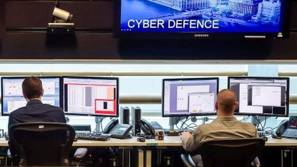 People sit at computers in the 24 hour Operations Room inside GCHQ, Cheltenham on 17 November, 2015.