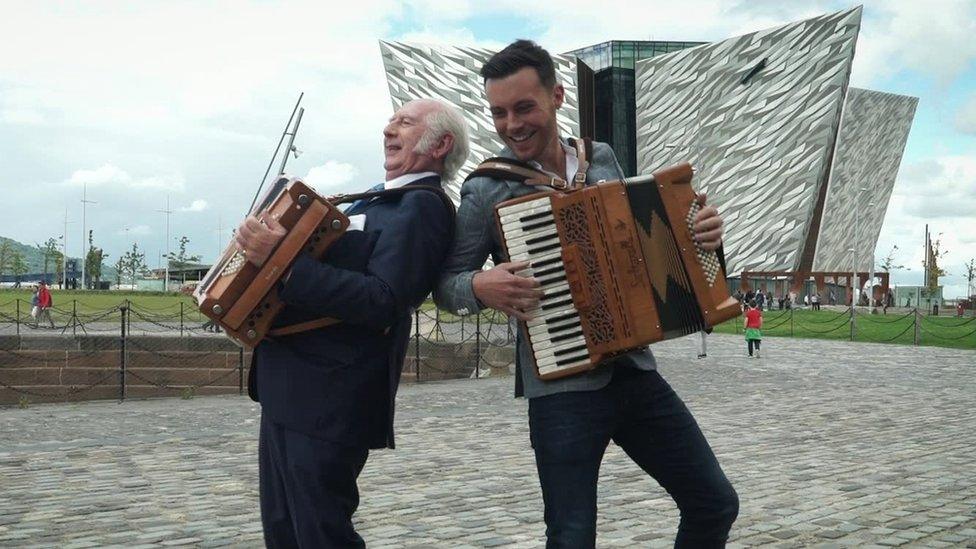 Mick Foster and Nathan Carter infront of the Titanic building in Belfast