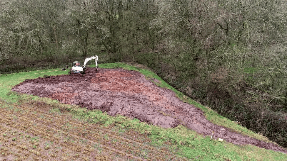 A digger on site at Crock Dumble, near Burton Joyce, preparing for groundwork.