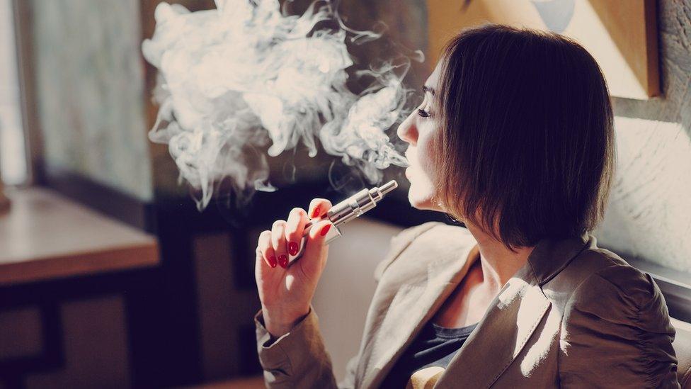 Woman vaping indoors