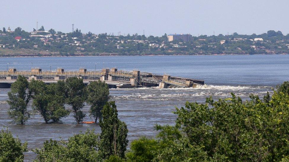 Water gushes over the Kakhovka dam