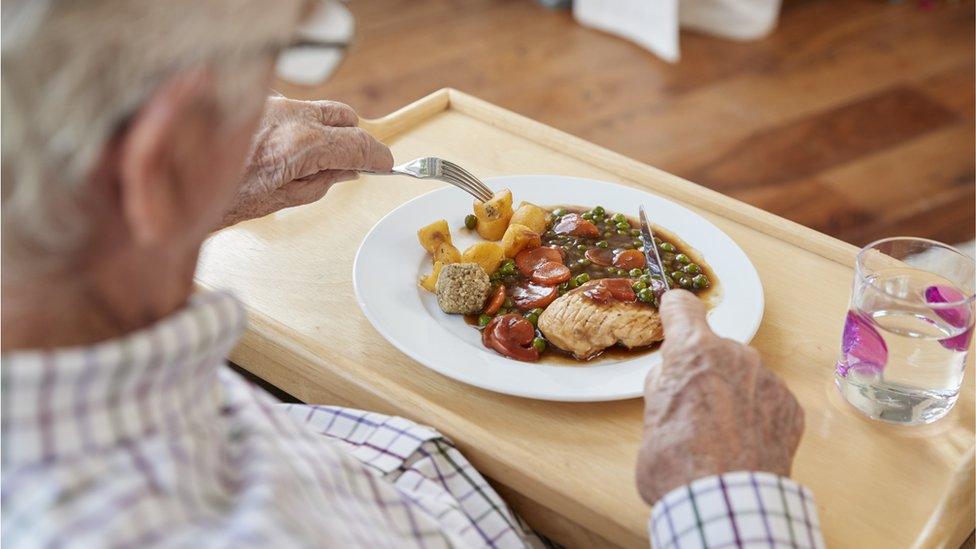 Elderly man eating