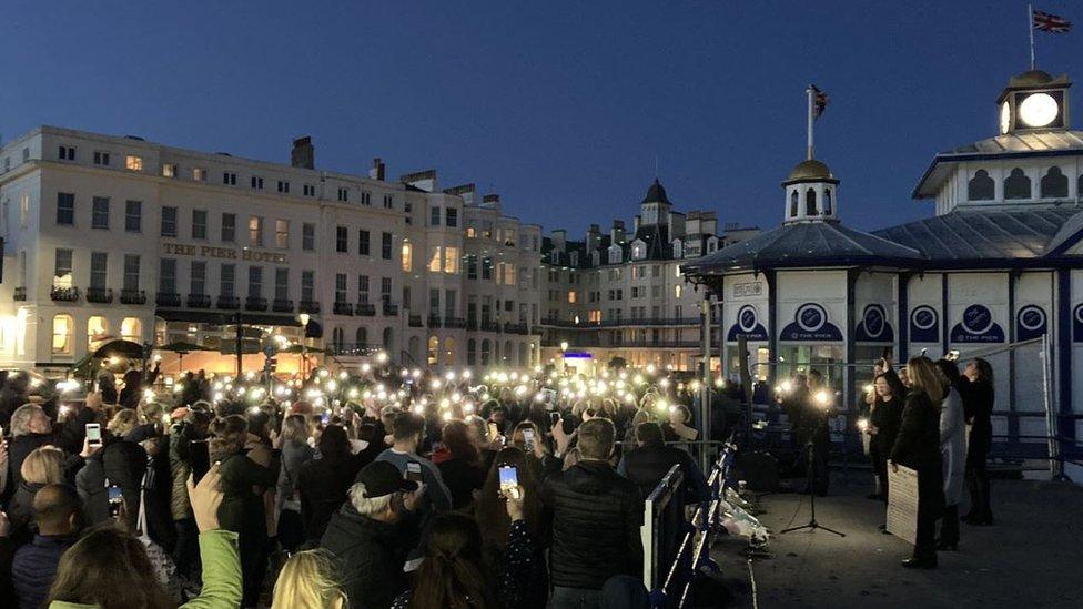 A crowd holding candles