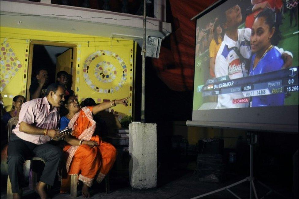 he parents of Indian gymnast Dipa Karmakar, Dulal Karmakar (L) and Gouri Karmakar (R) alongwith family members watch a projector screen in Agartala late August 14, 2016, as it shows the performance of Dipa in the vault finals of the gymnastics event at the 2016 Rio Olympic Games.