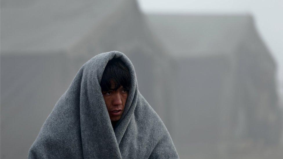 A migrant waits for transport to Slovenia after he registered at a new winter refugee camp in Slavonski Brod, Croatia, November 3, 2015