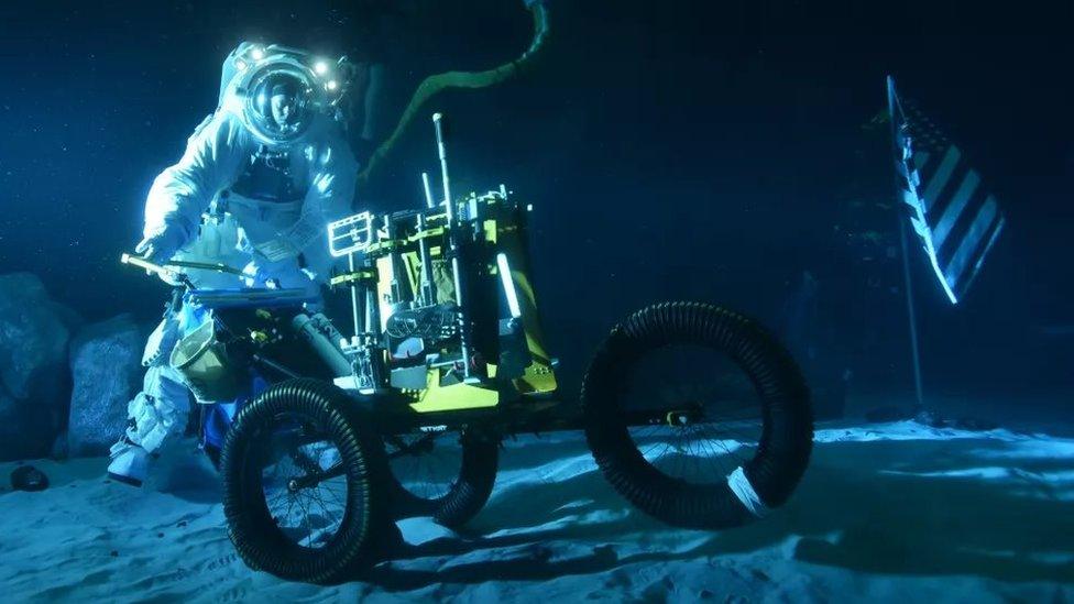 Astronaut shown under water in the tank